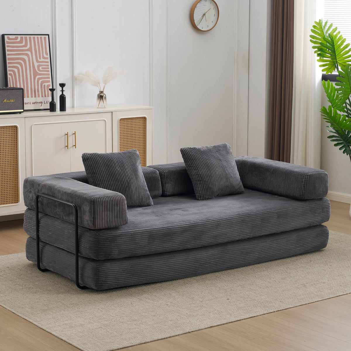 The Comfy 4-in-1 corduroy sofa bed in Charcoal Grey in a bright living room